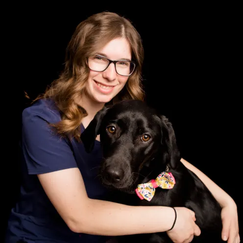A Kindness Animal Hospital staff member with a dog