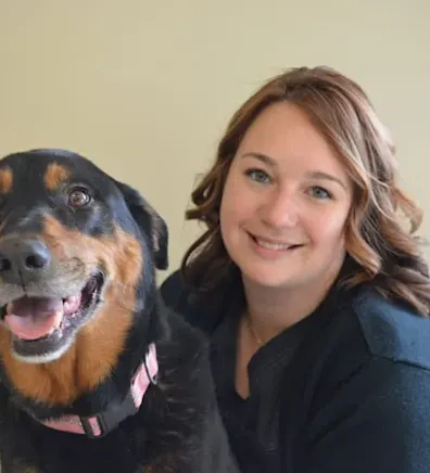 Staff photo of Monique hugging a dog Staff photo of Monique hugging a dog