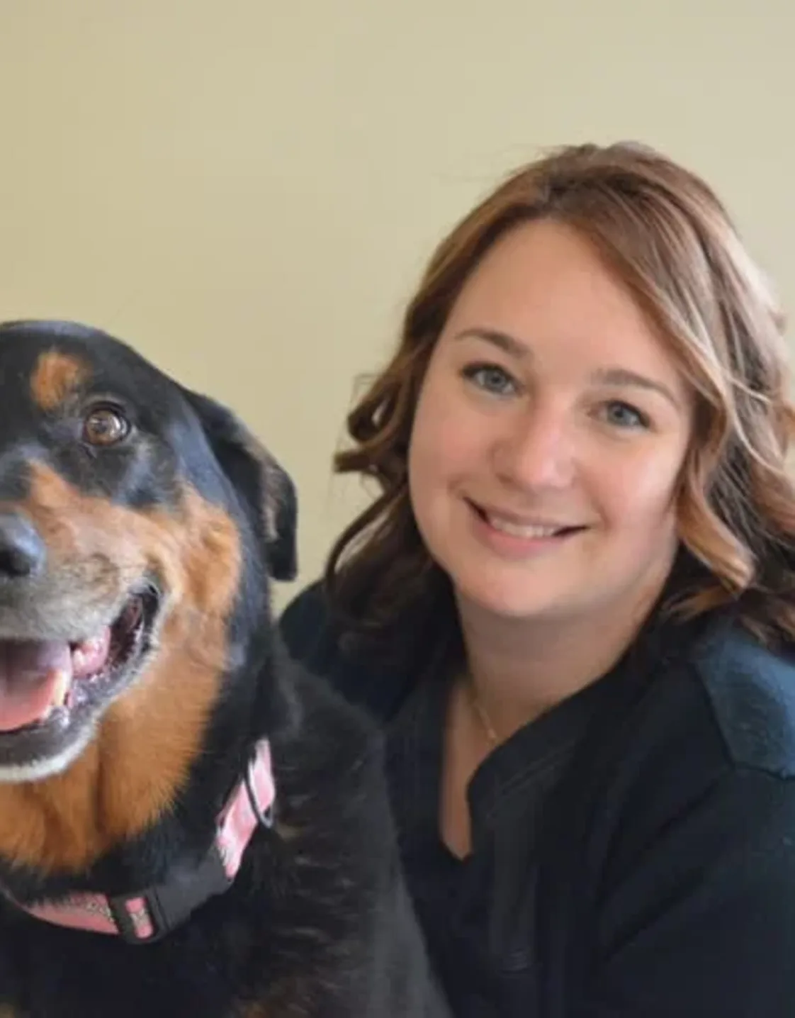 Staff photo of Monique hugging a dog Staff photo of Monique hugging a dog