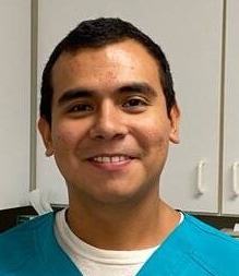 Edgar smiling in front of a cabinet at Carver Street Animal Hospital