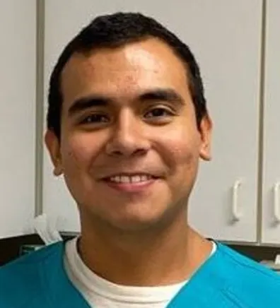 Edgar smiling in front of a cabinet at Carver Street Animal Hospital