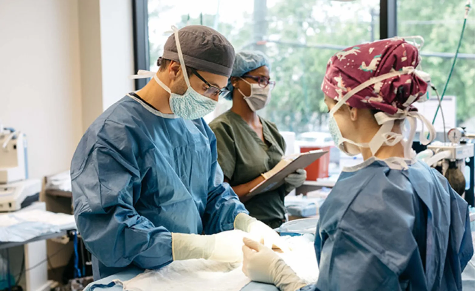 Three staff members with masks on working 