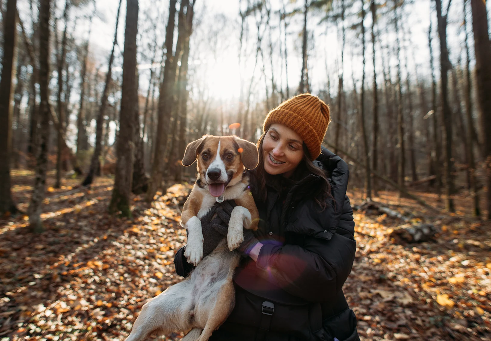Woman holding dog in forest Woman holding dog in forest