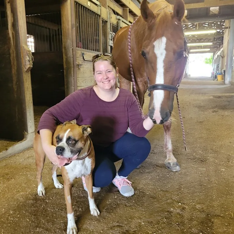 A veterinarian posing with dog and horse A veterinarian posing with dog and horse