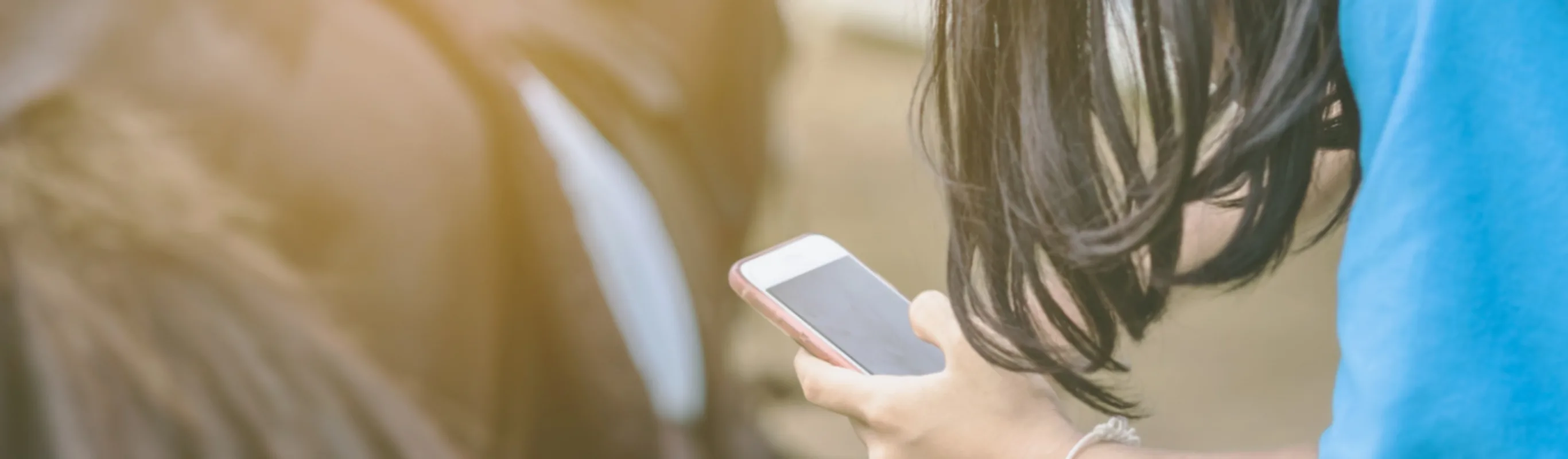 Person on their phone next to a horse Person on their phone next to a horse
