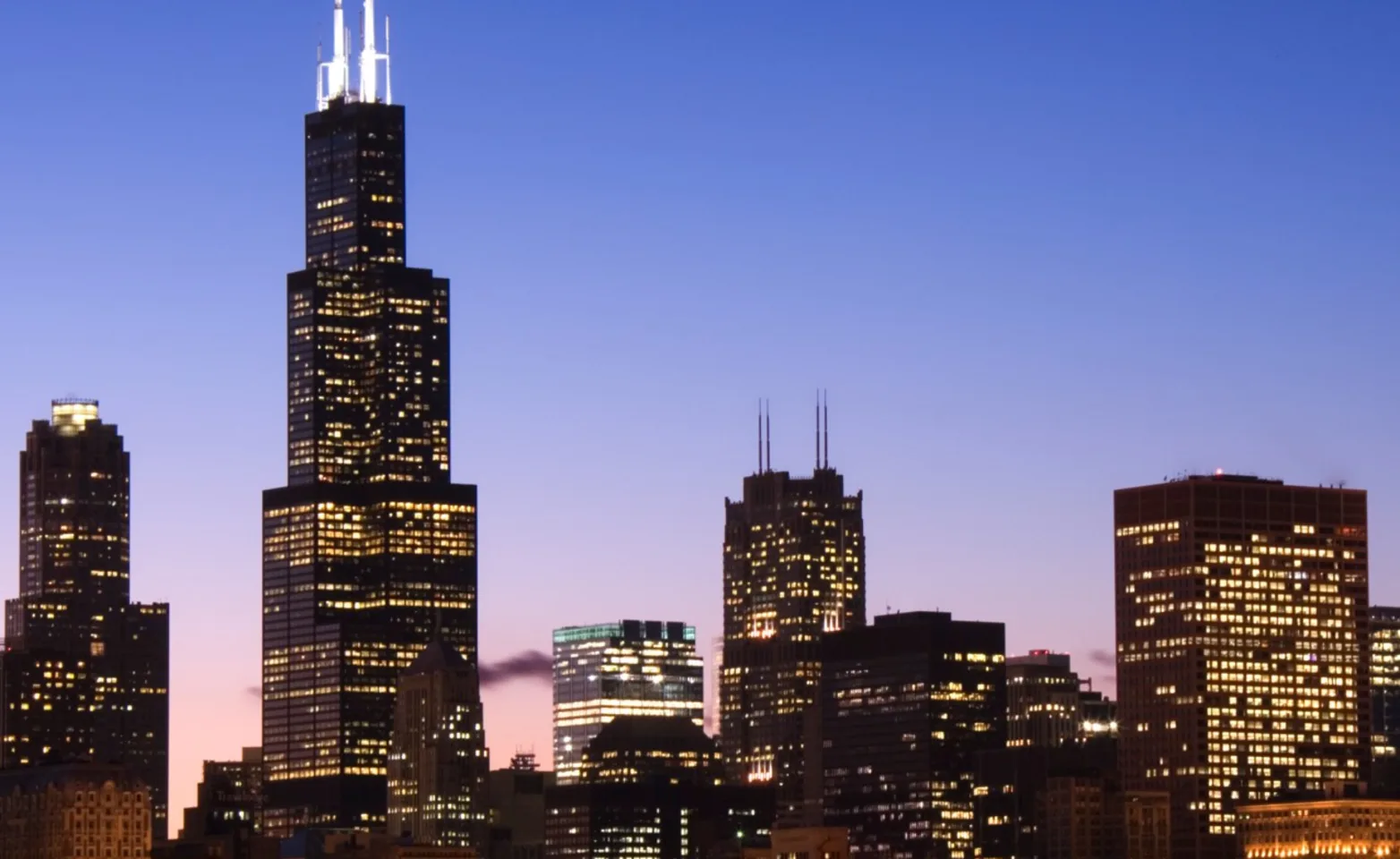 Silhouetted cityscape against a sunset. Silhouetted cityscape against a sunset.
