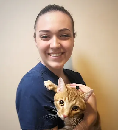 Riley McMonigle holding an orange cat Riley McMonigle holding an orange cat