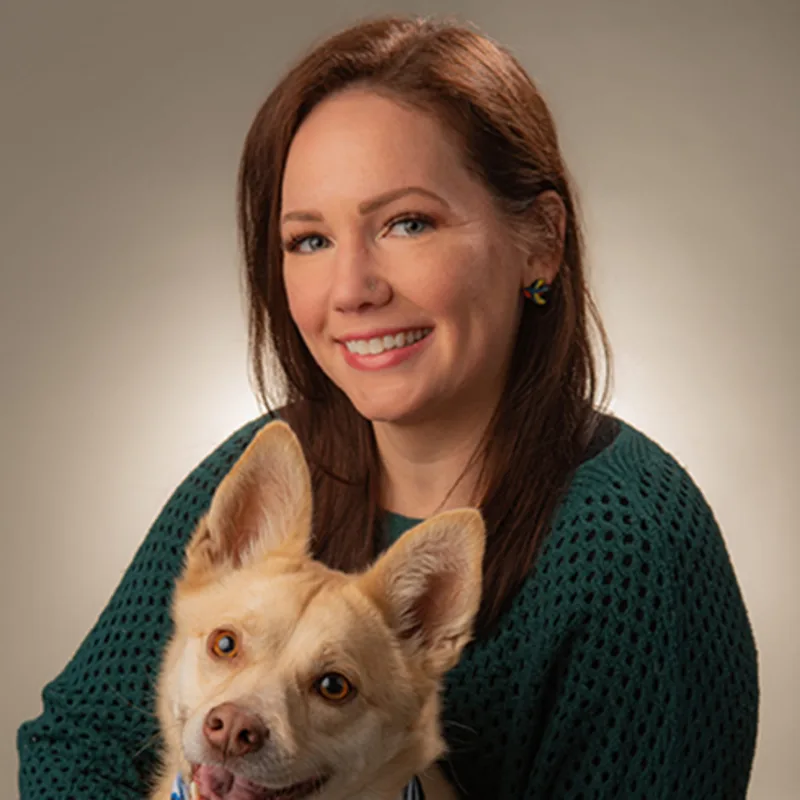 Melissa Mazur holding a dog with a bandana Melissa Mazur holding a dog with a bandana