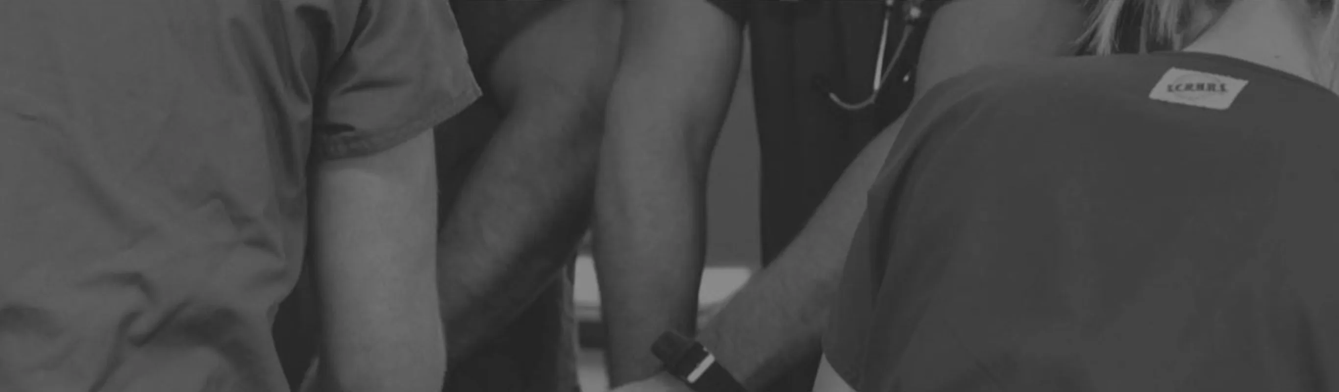 Black and white photo of staff in scrubs Black and white photo of staff in scrubs