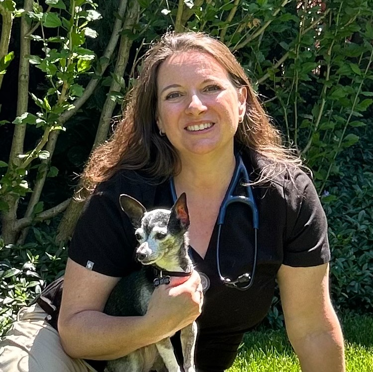 Jenn smiling with two dogs