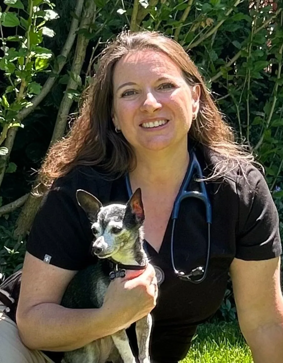 Jenn smiling with two dogs Jenn smiling with two dogs