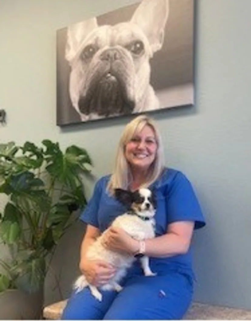 Jessica with black dog at Stonecrest Animal Hospital