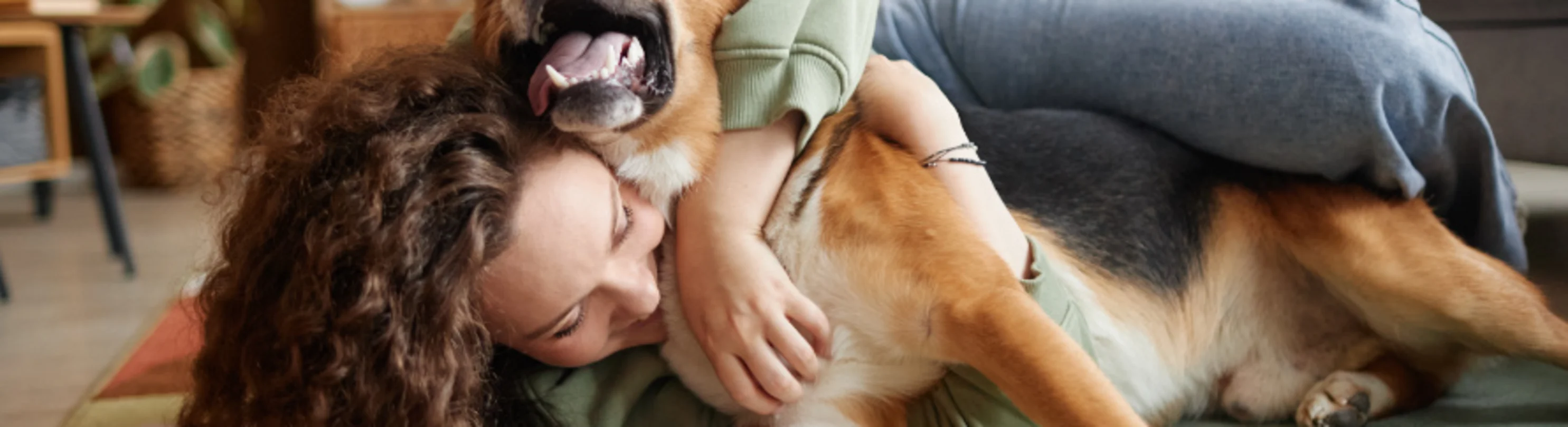 Woman Hugging Dog in Living Room Woman Hugging Dog in Living Room