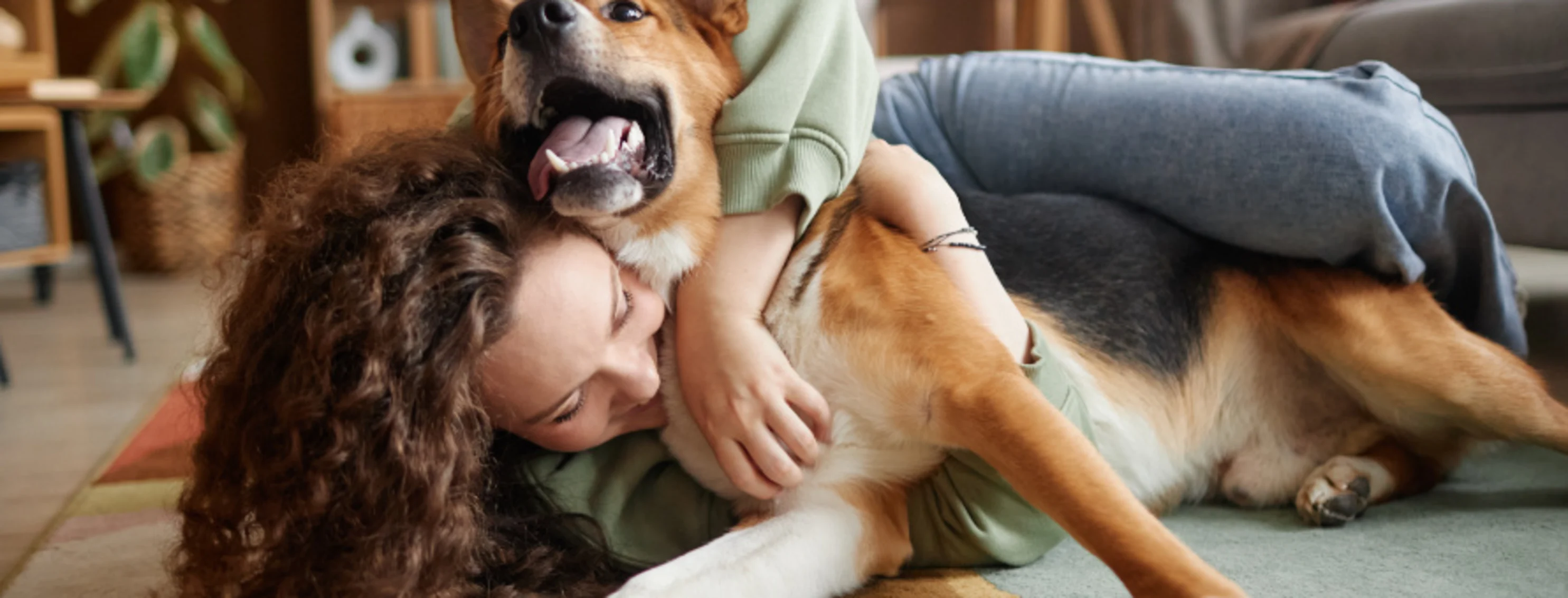 Woman Hugging Dog in Living Room Woman Hugging Dog in Living Room
