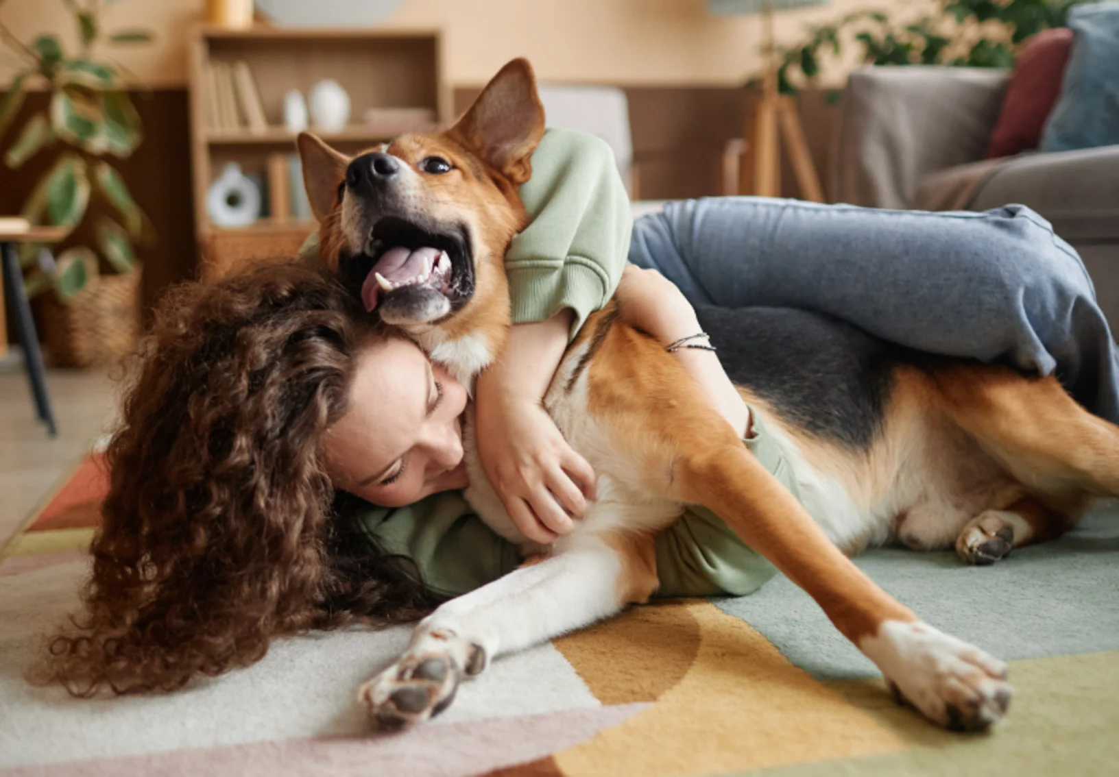 Woman Hugging Dog in Living Room Woman Hugging Dog in Living Room