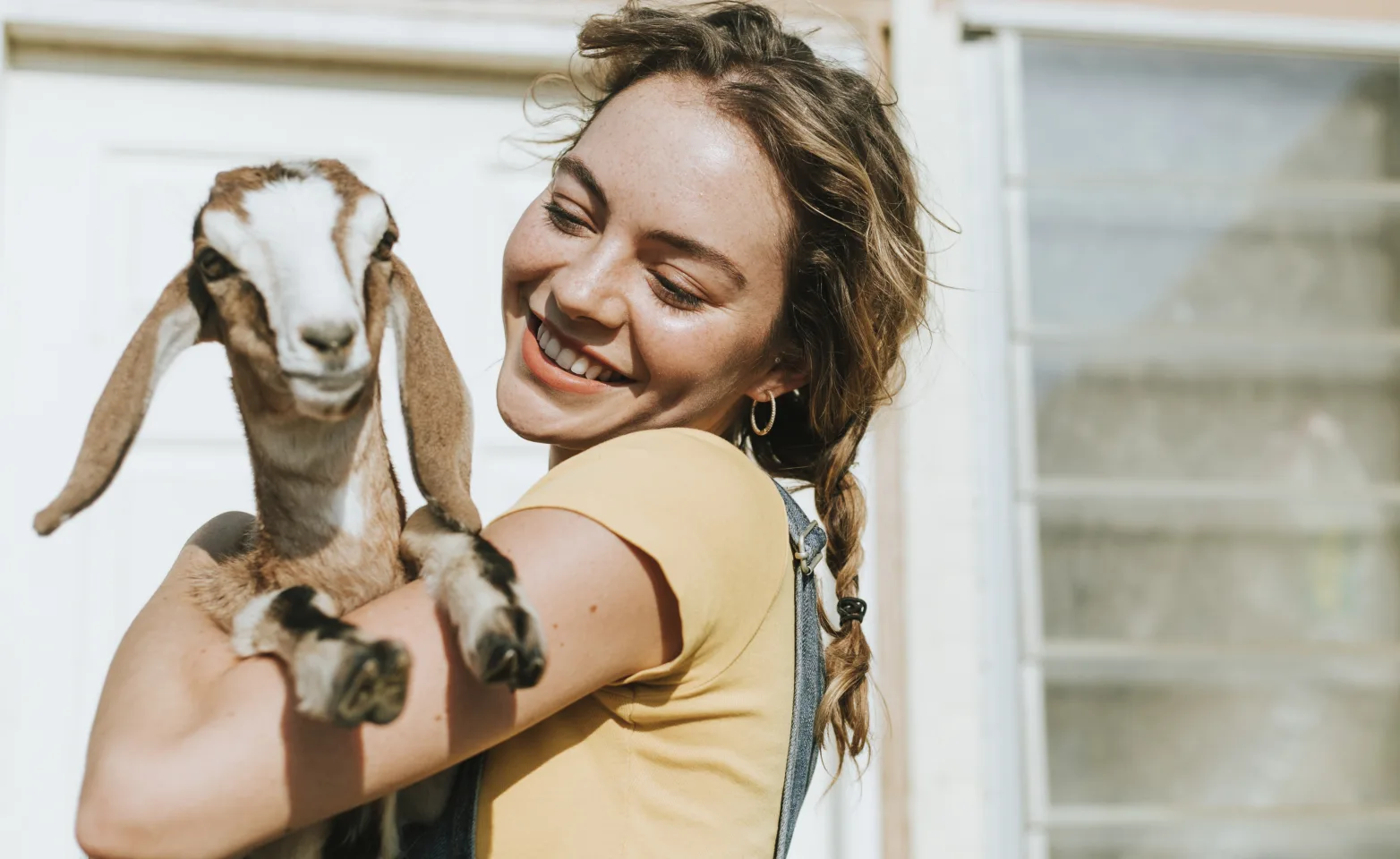 Woman with goat holding up