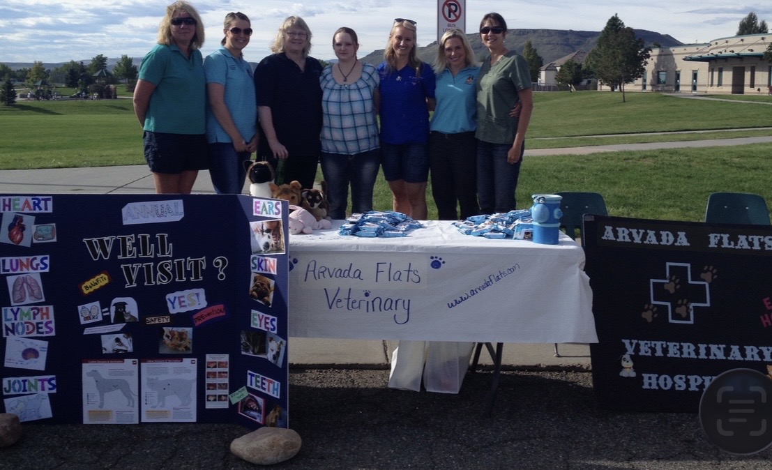 Seven team members in front of the Arvada flats veterinary hospital event table