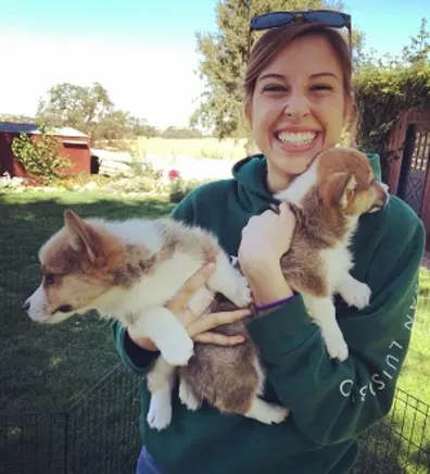 Maddie holding onto two puppies. Maddie holding onto two puppies.