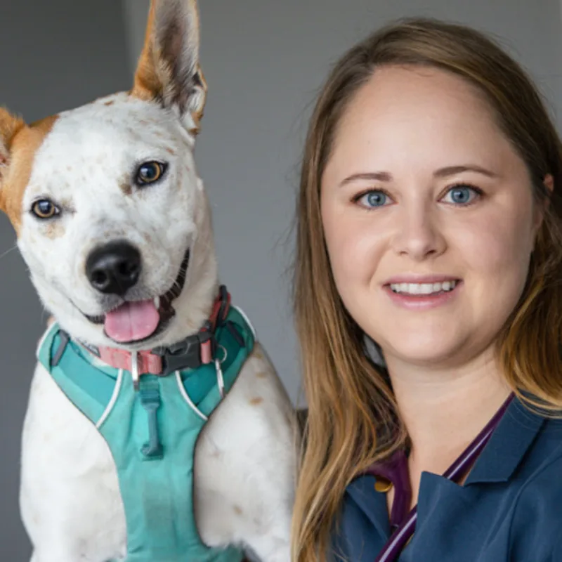 Dr. Elyse Mosco with a small orange and white dog Dr. Elyse Mosco with a small orange and white dog