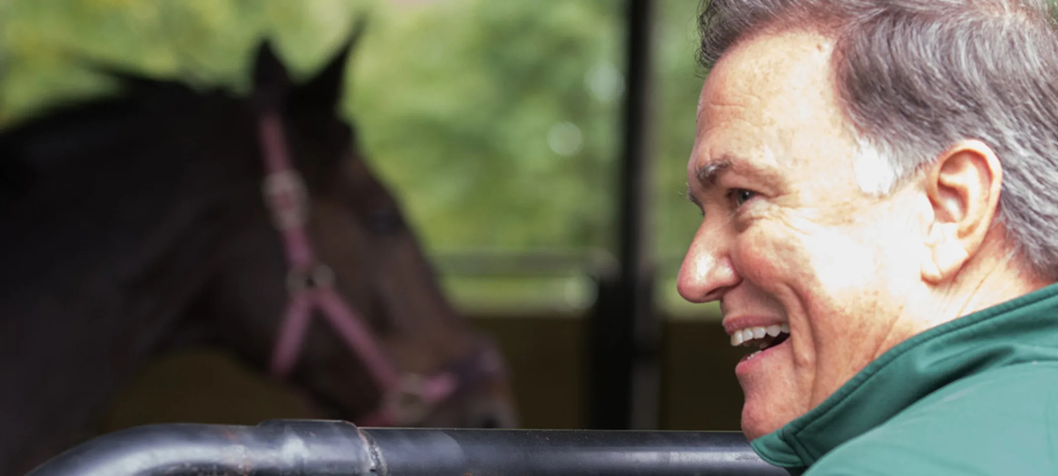 Allen Kent smiling with a horse in the background Allen Kent smiling with a horse in the background