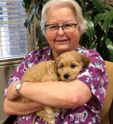 Brenda holding tan puppy