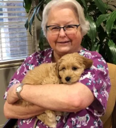 Brenda holding tan puppy Brenda holding tan puppy