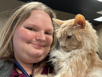 Staff smiling with a cat