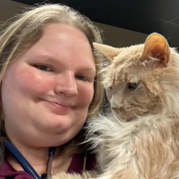 Staff smiling with a cat Staff smiling with a cat