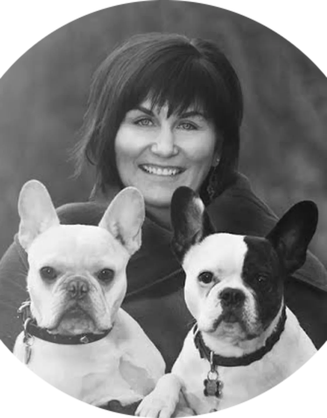 Dr. Geri Reimer holding up two of her dogs for a portrait picture Dr. Geri Reimer holding up two of her dogs for a portrait picture