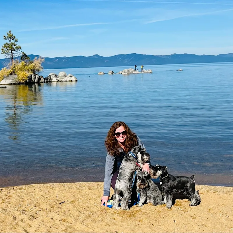 Rebecca Conway with two small black dogs and a giant, furry, white dog. Rebecca Conway with two small black dogs and a giant, furry, white dog.