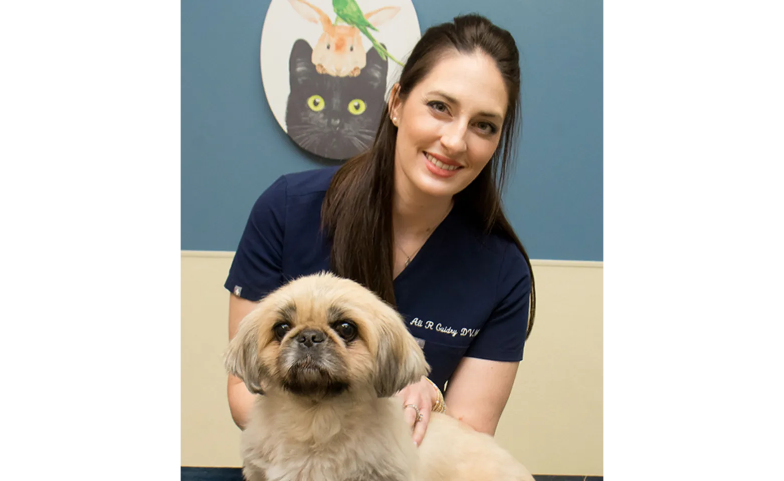 Dr. Guidry smiling with dog Dr. Guidry smiling with dog