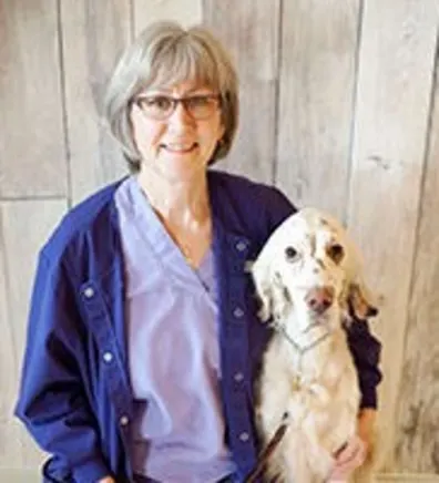 Betty Caldwell with a dog under her arm Betty Caldwell with a dog under her arm