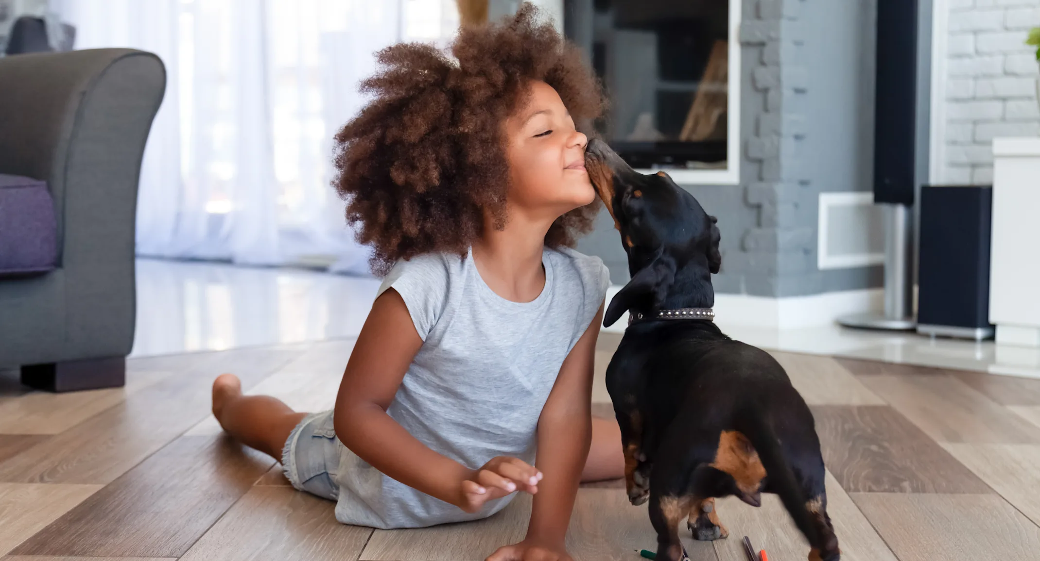 Kid with dog licking his nose