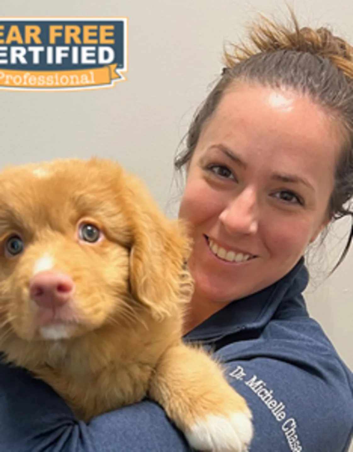 Dr. Michelle Chase holding a dog Dr. Michelle Chase holding a dog