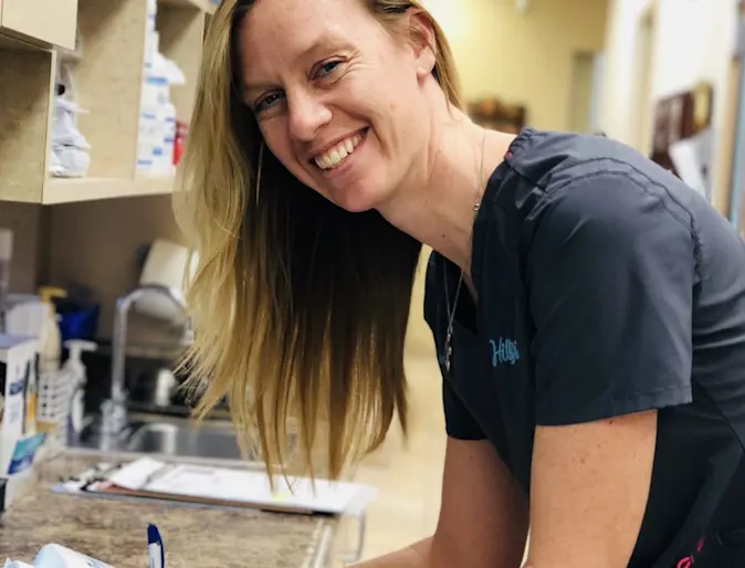 Hillside Animal Hospital's Female Staff Member smiling for the camera in the lab room Hillside Animal Hospital's Female Staff Member smiling for the camera in the lab room