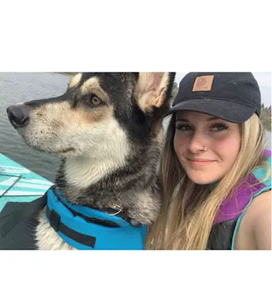 Brooke Chubey on a canoe with a dog Brooke Chubey on a canoe with a dog