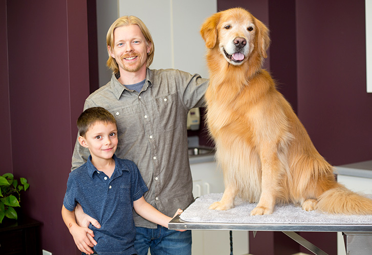 Family posed with dog