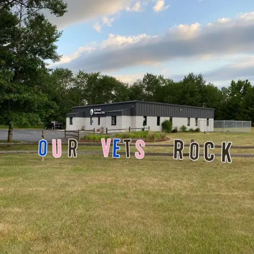 A sign reading 'Our Vets Rock' on a lawn.