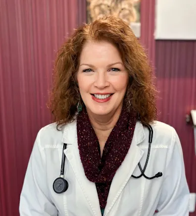 Dr. Weigt smiling in her white coat. Dr. Weigt smiling in her white coat.