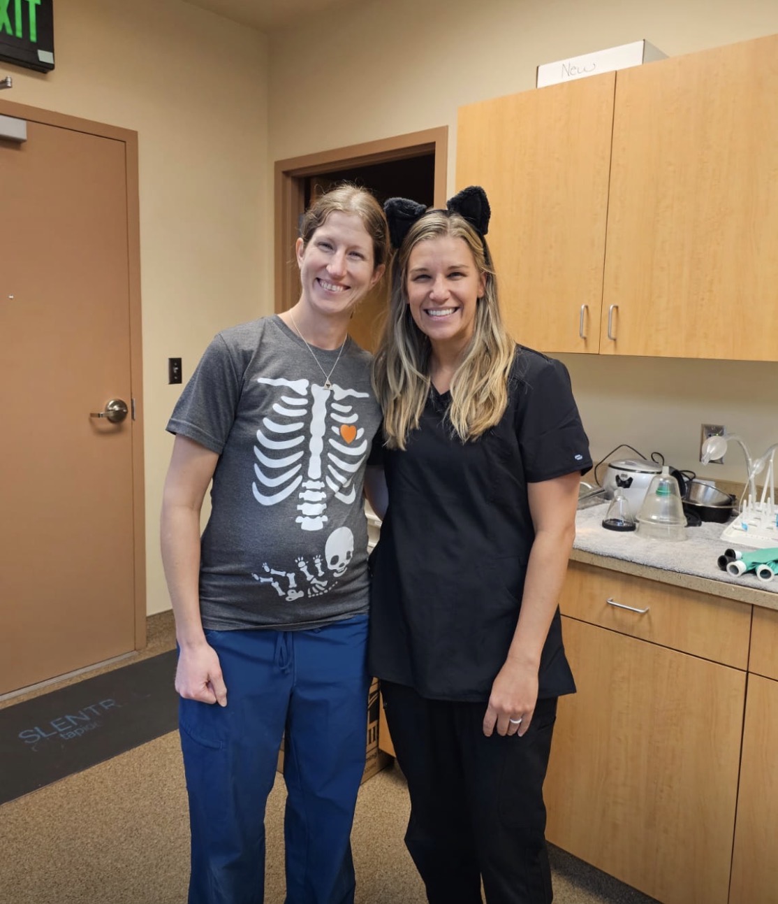 Two team members wearing a mouse costume