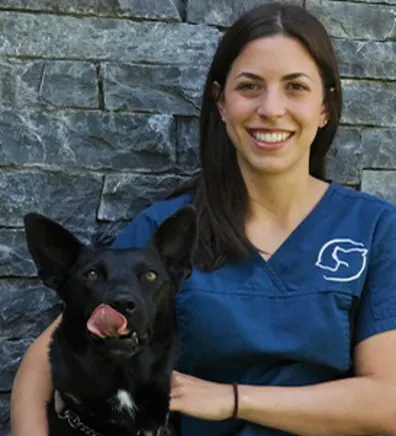 Cara with a black dog at Mountainside Animal Hospital