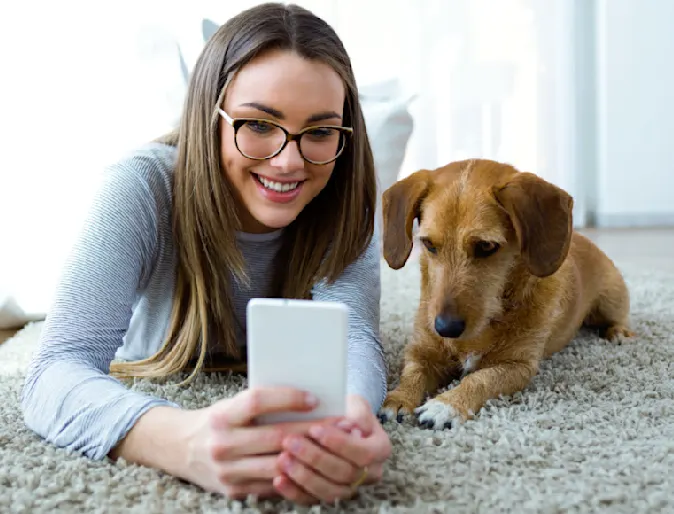 Girl on Phone with Dog Lying on Carpet Girl on Phone with Dog Lying on Carpet