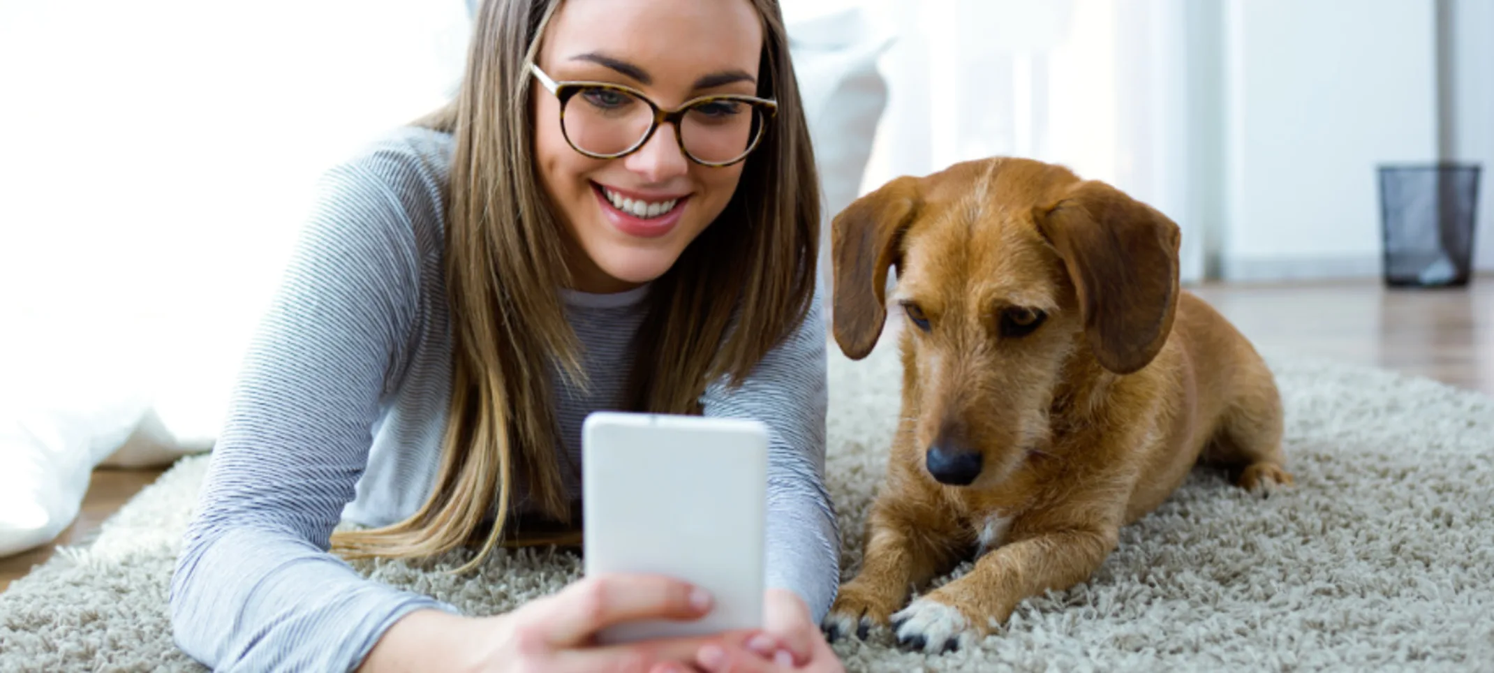 Girl on Phone with Dog Lying on Carpet Girl on Phone with Dog Lying on Carpet
