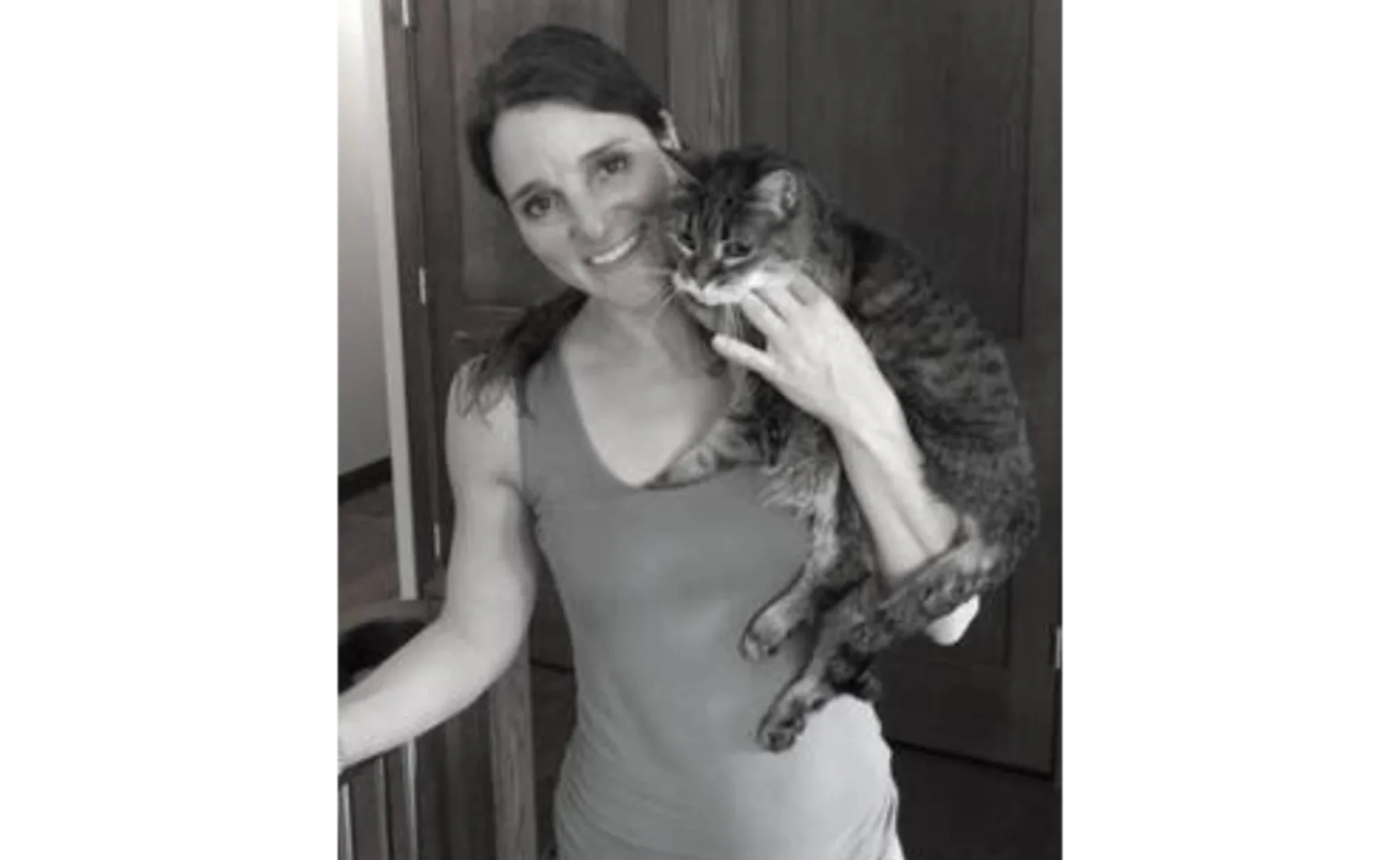 Black and white photo of Dr. Bianca Bauer holding a cat