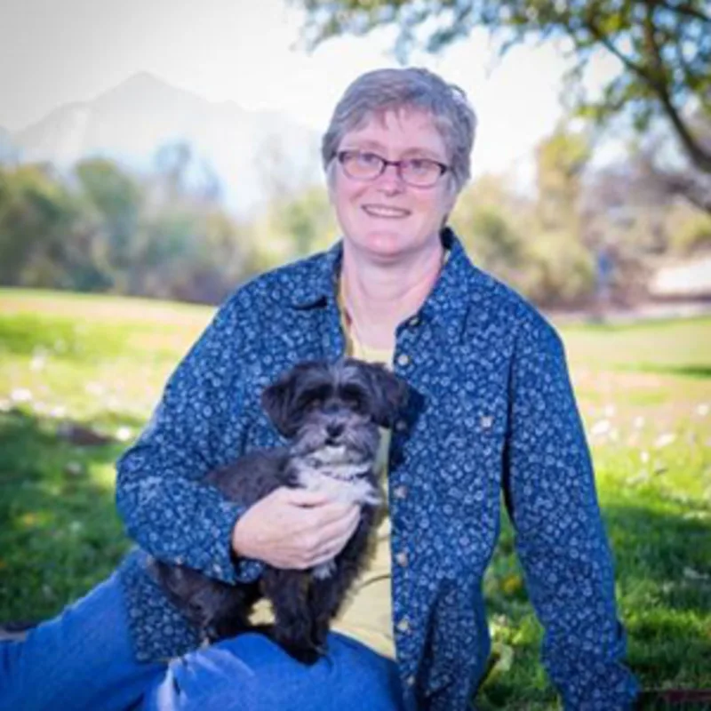 Rebecca Laton holding a gray and white small dog Rebecca Laton holding a gray and white small dog