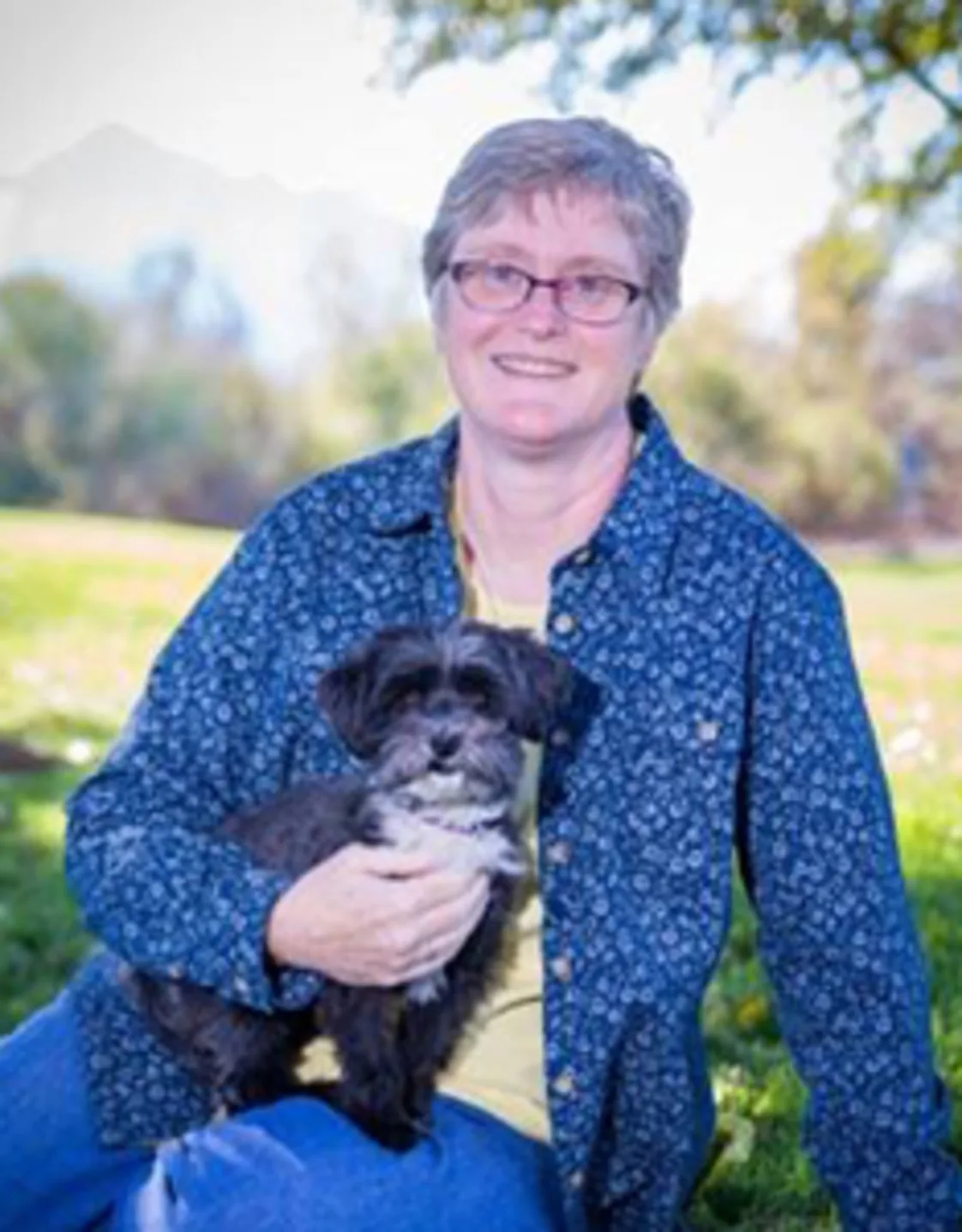 Rebecca Laton holding a gray and white small dog Rebecca Laton holding a gray and white small dog