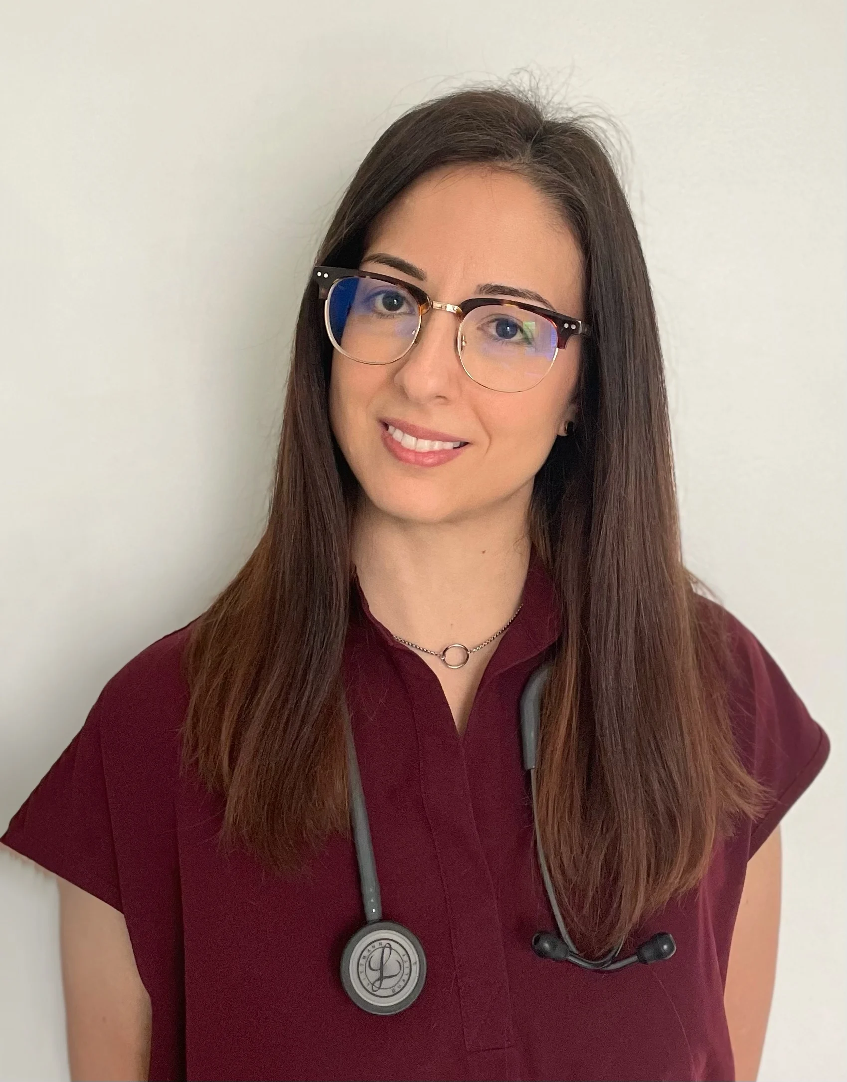 Dr. Carla Germano VMD in scrubs posing for the camera.