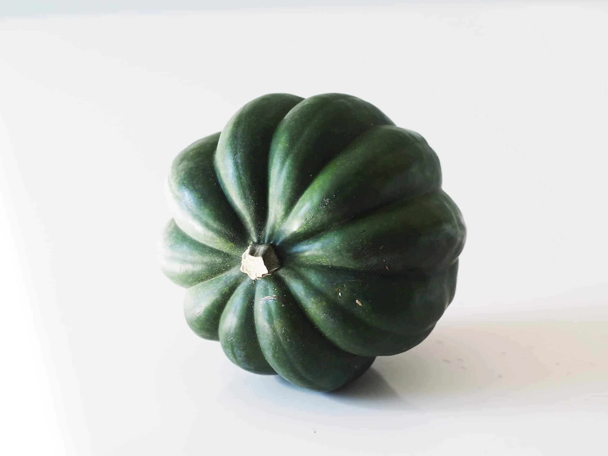 a whole acorn squash on its side