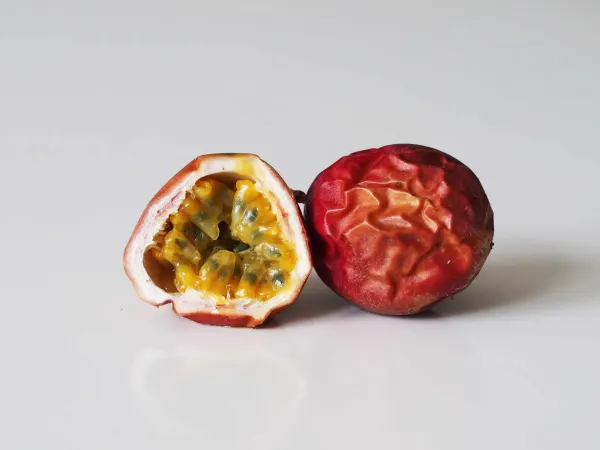 a ripe passion fruit cut halfway open before being prepared for babies starting solids