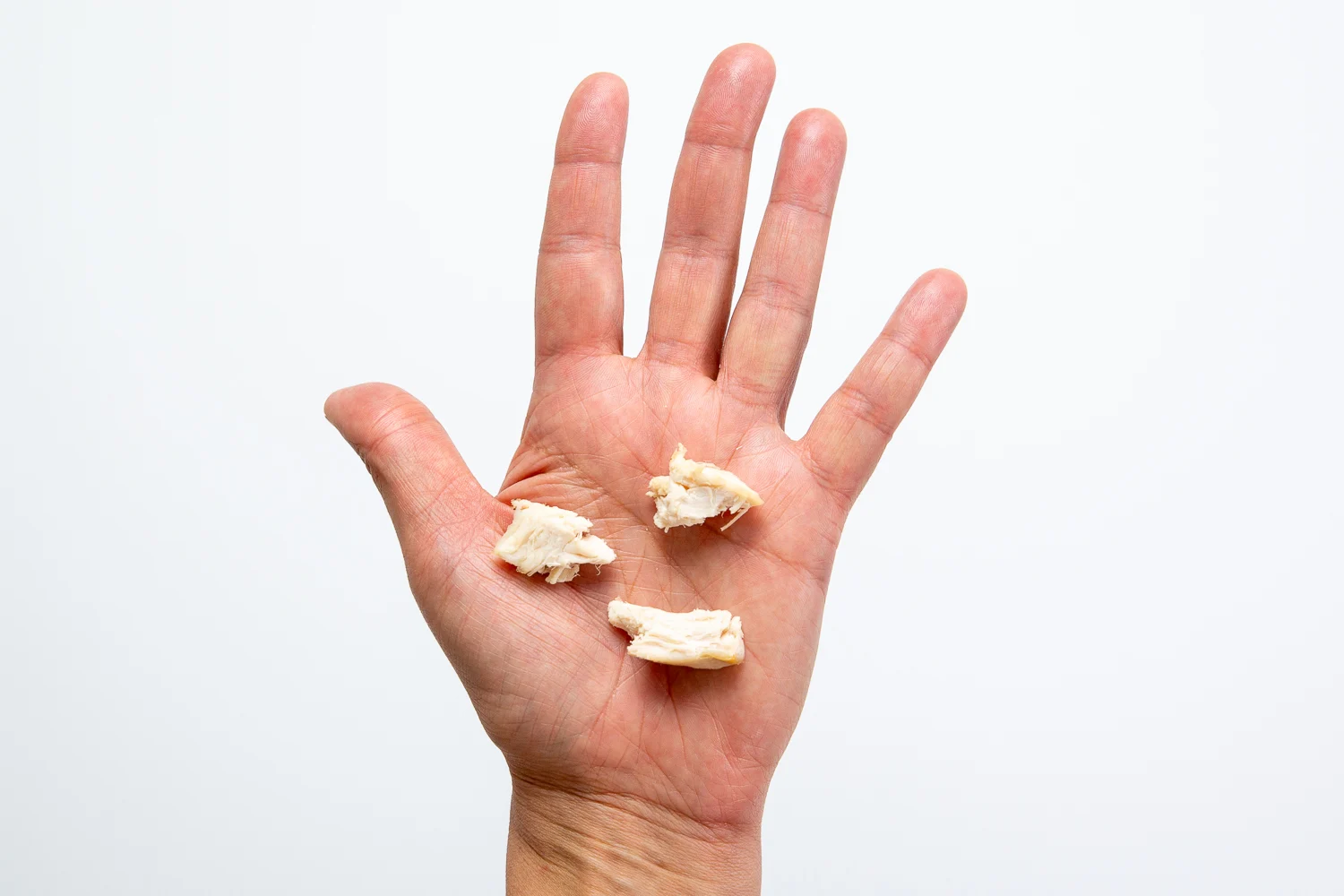 Chicken bite sized pieces hand pic